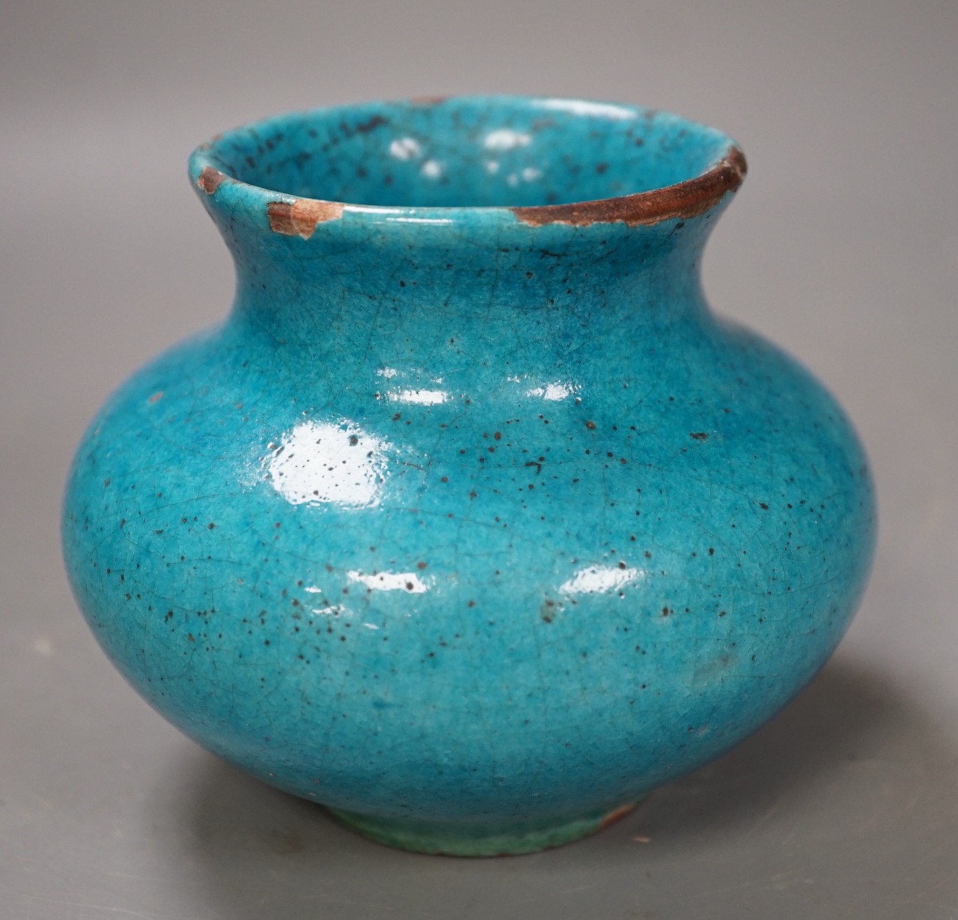 A Kashan style turquoise glazed vase. 10cm tall